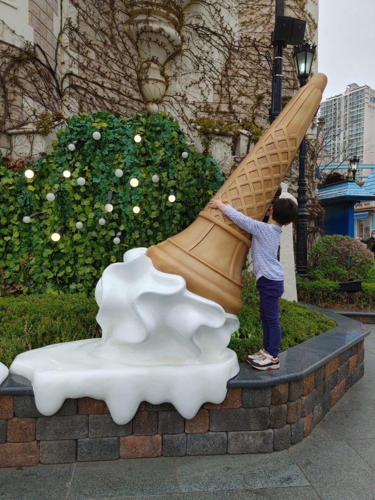 little boy hugging fake ice cream cone at Lotte Amusement park in Seoul
